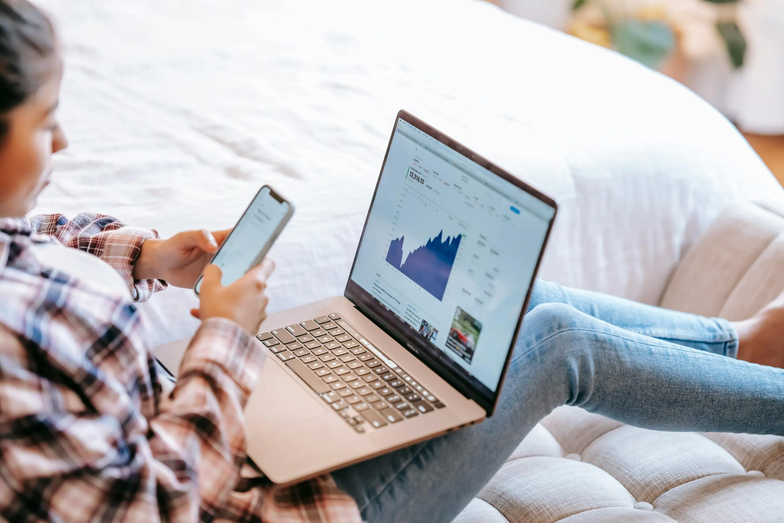 A girl using her computer to engage in stock market activities with the best brokers